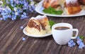 Pieces of chocolate marble cake, blue flowers and coffee Royalty Free Stock Photo