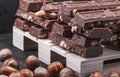 Pieces of  chocolate with whole hazelnuts. On the pallet .Brown tonality. Royalty Free Stock Photo