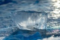 Pieces of clear blue ice of lake Baikal in the winter sunlight Royalty Free Stock Photo