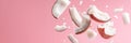 Pieces of coconut floating on pink background Royalty Free Stock Photo