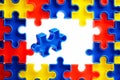 Pieces from a colorful jigsaw puzzle arranged to form a page on white background. Break barriers together for autism