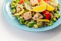 Pieces of cooked salmon and edamame soya beans with red pepper  and baby leaf spinach, served with brown long grain rice with Royalty Free Stock Photo