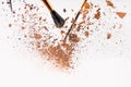 Pieces of cosmetic powder with brushes falling Royalty Free Stock Photo