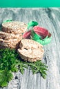 Pieces of crispbread near measuring tape and green arugula on grey background. Diet concept. Healthy food.