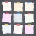 Pieces of crumpled cut colorful lined note paper are stuck on dark gray background Royalty Free Stock Photo