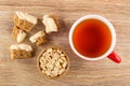 Pieces of sherbet with peanuts, cup with tea, bamboo bowl with peanuts on table. Top view Royalty Free Stock Photo