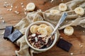 Pieces of dark chocolate and banana accompany light cereal breakfast Royalty Free Stock Photo