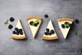 Pieces of delicious cheesecake with blackberries on background, flat lay