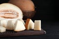 Pieces of delicious honey melon on black wooden table, closeup Royalty Free Stock Photo