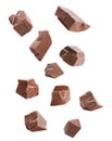 Pieces of delicious milk chocolate falling on background