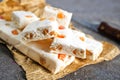 Pieces of delicious nutty nougat on table