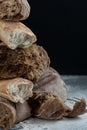 Pieces of different broken fresh bread close-up on a black background.. Royalty Free Stock Photo