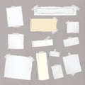 Pieces of different size ripped note, notebook, copybook paper sheets stuck with sticky tape on squared pattern