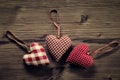 3 pieces of fabric hearts, polka dots , plaid, on wood background