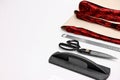Pieces of fabric, measurements, scissors and other tools on white table, closeup. Space for text Royalty Free Stock Photo