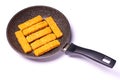 Pieces of fish in batter on a frying pan isolated on a white background Royalty Free Stock Photo