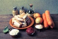 Pieces of fresh fish on a plate, vegetables, flour, tomatoe past Royalty Free Stock Photo