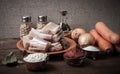 Pieces of fresh fish on a plate, vegetables, flour, tomatoe past Royalty Free Stock Photo