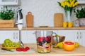 Pieces of fresh fruits and berries in the blender jar ready for preparing smoothie Royalty Free Stock Photo