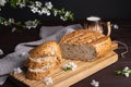 Pieces of fresh homemade rye bread with clay mug of milk on wooden cutting board. Healthy breakfast Royalty Free Stock Photo