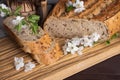 Pieces of fresh homemade rye bread with clay mug of milk on wooden cutting board. Healthy breakfast Royalty Free Stock Photo