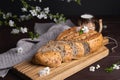 Pieces of fresh homemade rye bread with clay mug of milk on wooden cutting board. Healthy breakfast Royalty Free Stock Photo