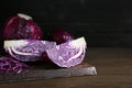 Pieces of fresh red cabbage on wooden table. Space for text Royalty Free Stock Photo