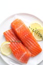 Pieces of fresh salmon with thyme and lemon on white table, top view Royalty Free Stock Photo