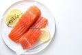 Pieces of fresh salmon with thyme and lemon on white table, top view. Space for text Royalty Free Stock Photo