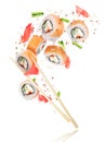 Pieces of fresh sushi with chopsticks frozen in the air Royalty Free Stock Photo