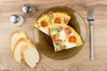 Pieces of fried eggs with sausage, tomatoes in plate, bread Royalty Free Stock Photo