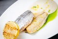 pieces of fried fish with sauce and fried lemon on a white plate side view Royalty Free Stock Photo