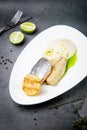pieces of fried fish with sauce and fried lemon on a white plate side view Royalty Free Stock Photo