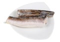 Pieces of frozen atlantic hake fish lying on a plate isolated