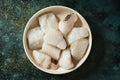 Pieces of frozen uncooked codfish in a plate