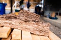 Pieces of glass insulation wool laying on wooden beams