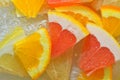 Pieces of grapefruit, orange fruit and honey pomelo in liquid with bubbles. Slices of grapefruit, orange fruit and honey Royalty Free Stock Photo