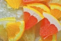 Pieces of grapefruit, orange fruit and honey pomelo in liquid with bubbles. Slices of grapefruit, orange fruit and honey Royalty Free Stock Photo