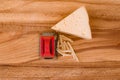 Pieces of grated cheese closeup on wooden Board Royalty Free Stock Photo