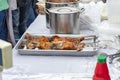 Pieces of grilled red fish are strung on skewers on a metal tray on the table. Royalty Free Stock Photo