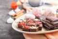A pieces of homemade chocolate with coconut candies and a cup of coffee on a black concrete background. side view, selective focus Royalty Free Stock Photo