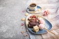 A pieces of homemade chocolate with coconut candies and a cup of coffee on a gray concrete background. side view, copy space Royalty Free Stock Photo