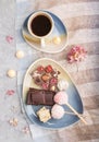 A pieces of homemade chocolate with coconut candies and a cup of coffee on a gray concrete background. top view, copy space Royalty Free Stock Photo