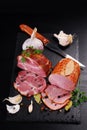 Pieces of homemade smoked pork ham on black background Royalty Free Stock Photo