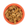 Pieces of honey roasted cashews in an orange bowl Royalty Free Stock Photo