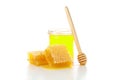 Pieces of honeycomb, glass jar and dipper isolated