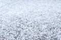 Pieces of the ice of a hail on the ground outdoors in springtime, unpredictable weather of the season, close up view