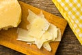 Pieces of Italian hard cheese on a wooden table