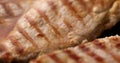 Pieces of meat are fried on a grill pan. Close-up dolly shot.