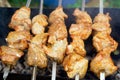 Pieces of meat are friend on fire on skewers on grill. close up Royalty Free Stock Photo